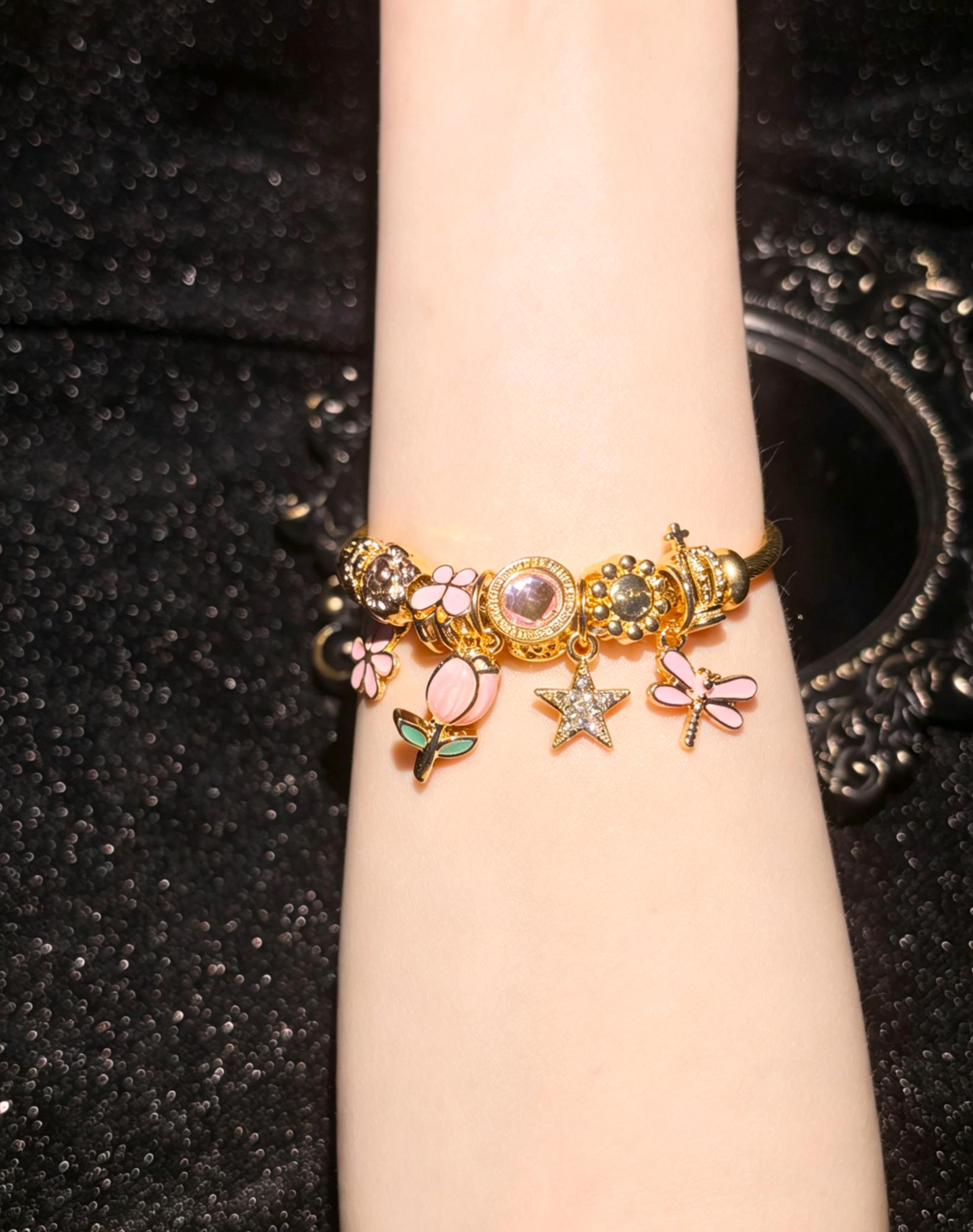 Women's Gold-Tone Open Bangle Bracelet with Pink Flower, Dragonfly, Star & Crown Charms, Stackable Costume Jewelry Gift