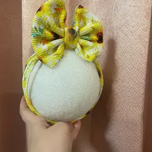 Sunflower Headwrap with Vibrant Bow Design and Glittery Center for Festive Looks