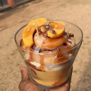 Peach Cobbler Cinnamon Roll with Caramel Sauce and Crumbled Toppings for a Sweet Treat