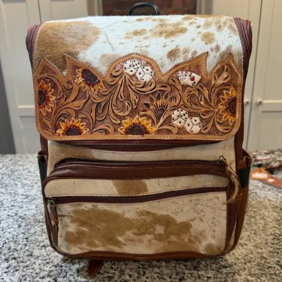 Genuine hand tooled, hand painted leather & cowhide backpacks with various designs- see options below! Genuine hand tooled, hand painted leather & cowhide backpacks with various designs- see options below!
