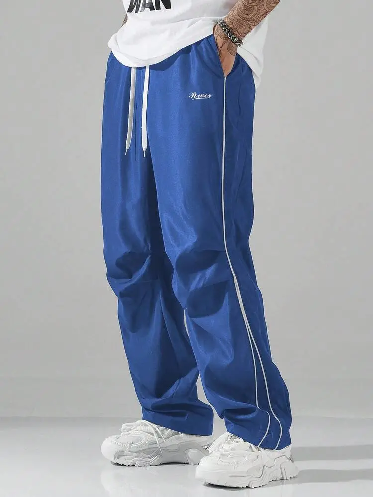 American high-street racer print wide-leg pants with a bad-boy cool vibe—draped casual long pants featuring side double-stripe detailing, an oversized wide-leg cut, and a drapey fabric. A matching couple’s option that adapts to diverse styling scenarios,