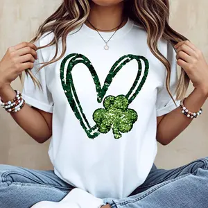 A crew neck T-shirt with a green heart and shamrock pattern is the perfect choice to celebrate St. Patrick's Day.