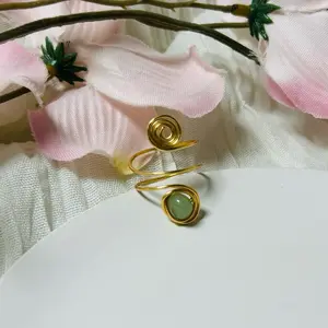 Vendant Spiral Ring. A delicate handmade spiral ring crafted with gold wire and a soft green and pink gemstone