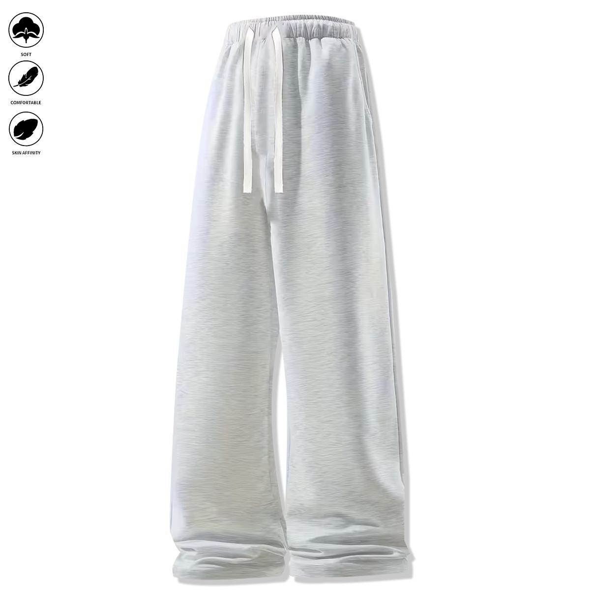 Men's loose-fit sweatpants, featuring a casual drawstring elastic waistband, wide legs, and jogger pockets. Comfortable for everyday wear and athletic bottoms.