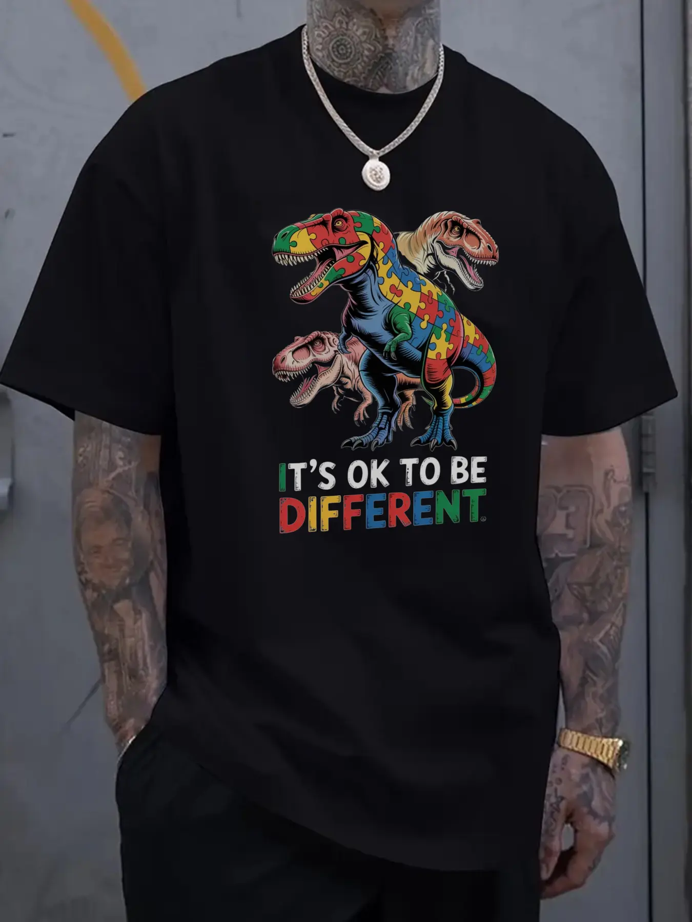 Men's Black Graphic T-Shirt with Colorful Dinosaur Print & "It's OK to Be Different" Slogan -  Cotton Casual Short Sleeve Tee, Regular Fit Round Neck Summer Top for Casual Attire, Dinosaur Shirt, Machine Washable Clothing, Bold Geometric Design
