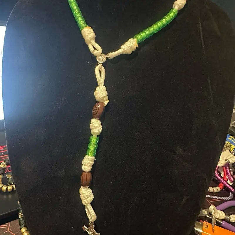 Handmade paracord 5 decade rosary blessed “The Reverse Eagles theme ” white with green and  football beads