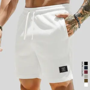 Men’s waffle-textured shorts with a checkered pattern, drawstring elastic waistband, soft and comfortable feel; pairs well with plaid shirts, printed short-sleeve summer clothing.