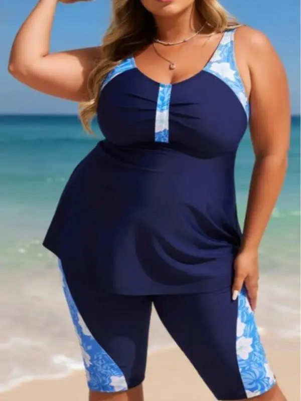 Plus Size Navy Floral Colorblock Separated Swimsuit Flowy navy tankini top with tropical floral print accents, paired with matching knee-length swim capris. Sporty, full-coverage design for water activities Summer Vibes