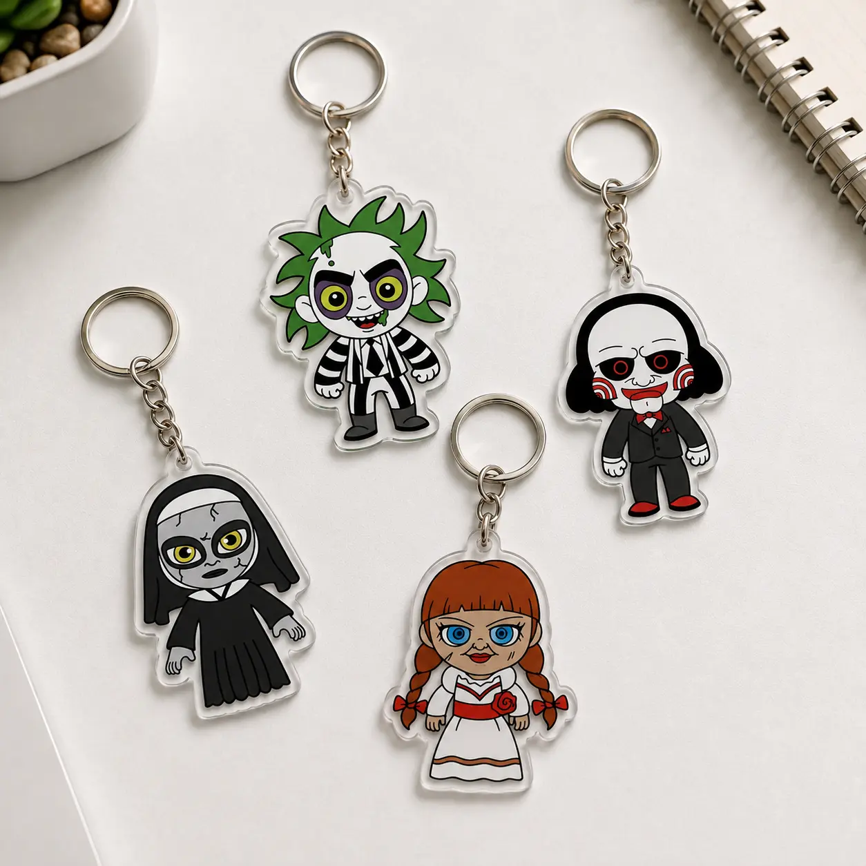 Spooky horror character acrylic keychain set with 4 creepy chibi designs for bags, keys and Halloween gifts