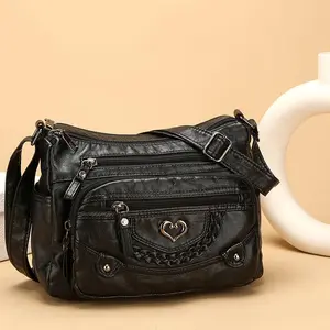 A stylish and soft genuine leather crossbody bag, designed for women, featuring multiple pockets, a heart-shaped pattern, and a spacious interior.  It's fashionable, versatile, and perfect for everyday use.