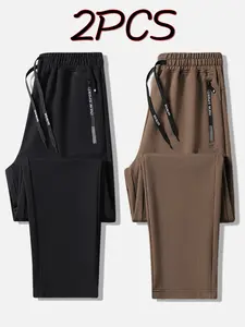 Men’s 2-pack all-season fashion athletic joggers with letter print, zippered pockets, and a drawstring; suitable for fitness and casual wear in all seasons; ideal for couples.