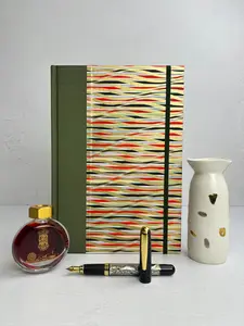 B5 192-page Hardcover Journal finished in olive green Japanese book cloth and gold, black and red geometric Chiyogami Paper