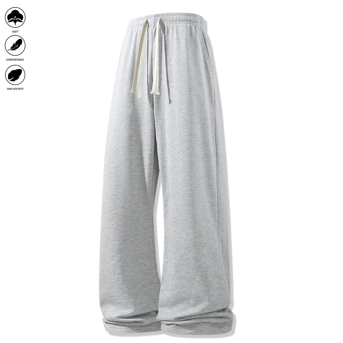 Men's loose-fit sweatpants, featuring a casual drawstring elastic waistband, wide legs, and jogger pockets. Comfortable for everyday wear and athletic bottoms.