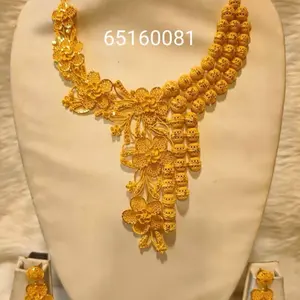 Gold plated necklace set with earrings and ring .