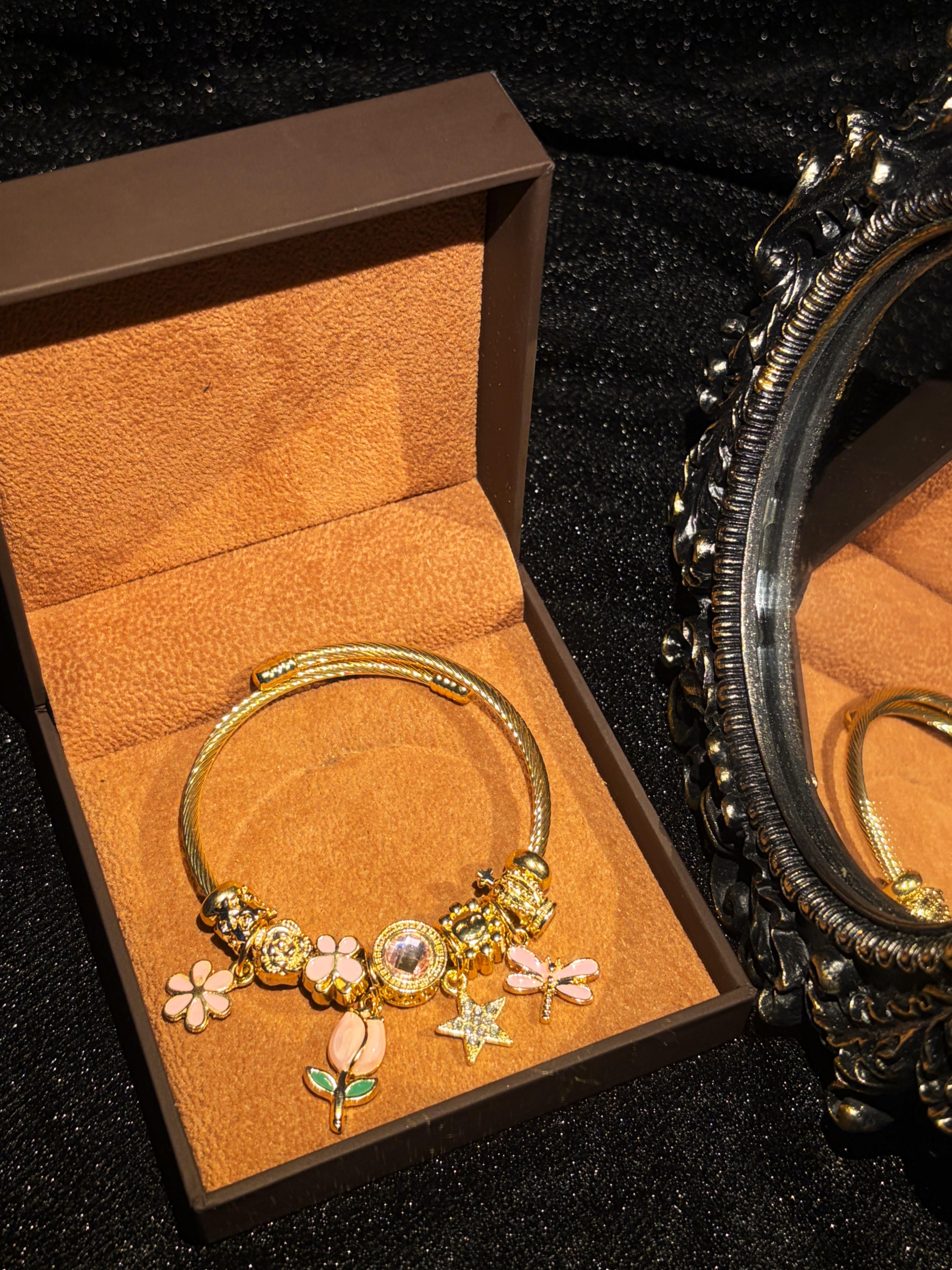 Women's Gold-Tone Open Bangle Bracelet with Pink Flower, Dragonfly, Star & Crown Charms, Stackable Costume Jewelry Gift