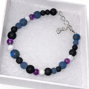 Black Acrylic and Glass Handmade Beaded bracelet with purple and white accent beads on stretch cord with chain for adjustment