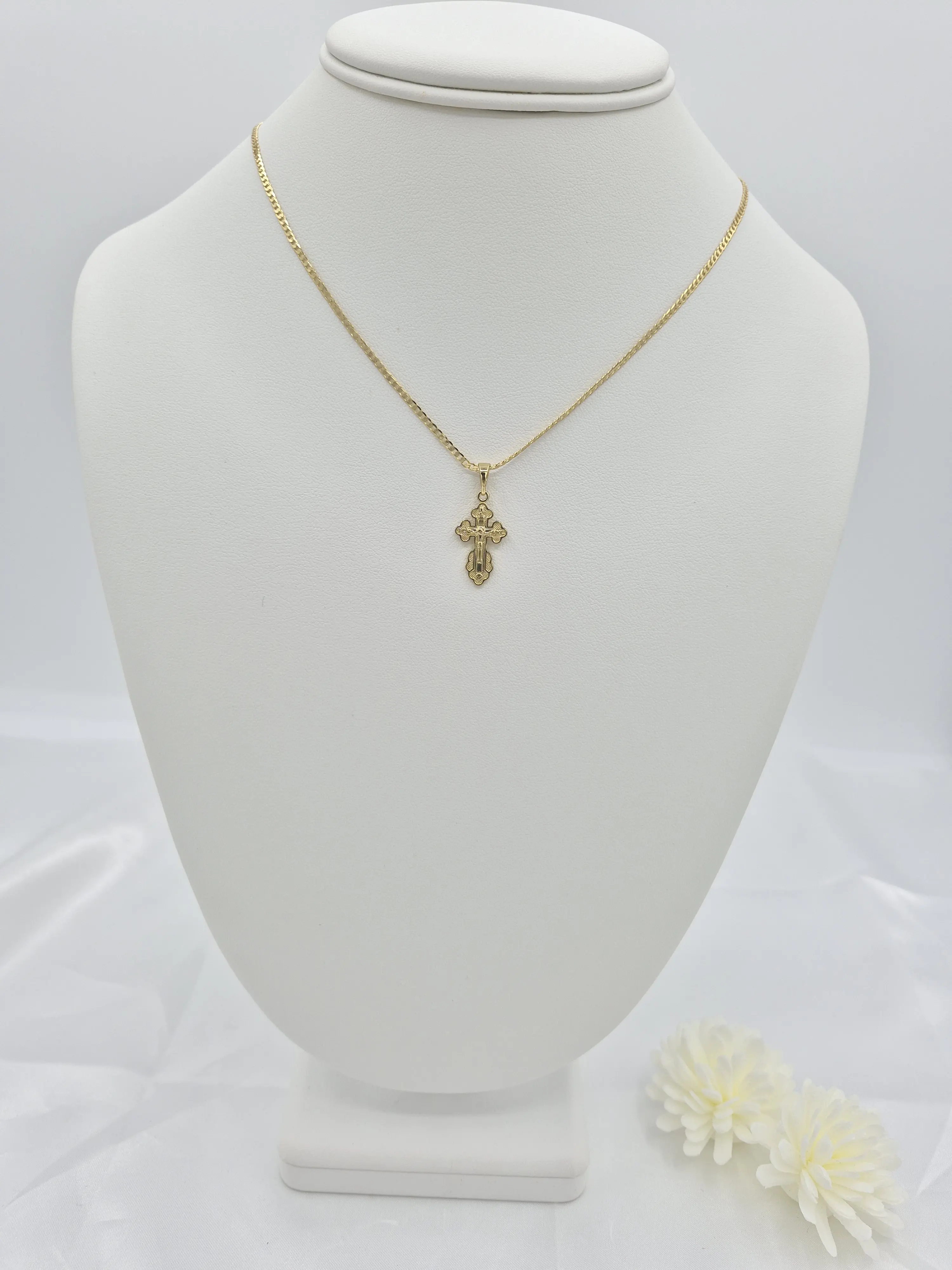 Chain with a small 14k gold plated crucifix pendant. (20)