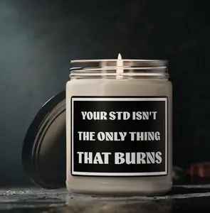 Scented soy candle that reads Your STD ISN'T THE ONLY THING THAT BURNS