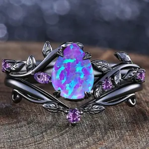 A set of two matte black earrings adorned with purple synthetic opal in pear and leaf patterns, suitable for festivals, parties, everyday wear, or as a gift.