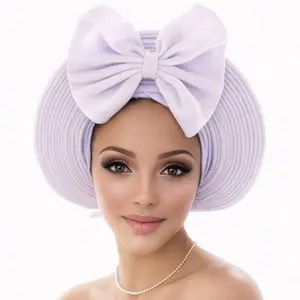 Elegant lavender gele with a beautiful bow design. Perfect for weddings, parties, and special occasions. Stylish and ready to wear.